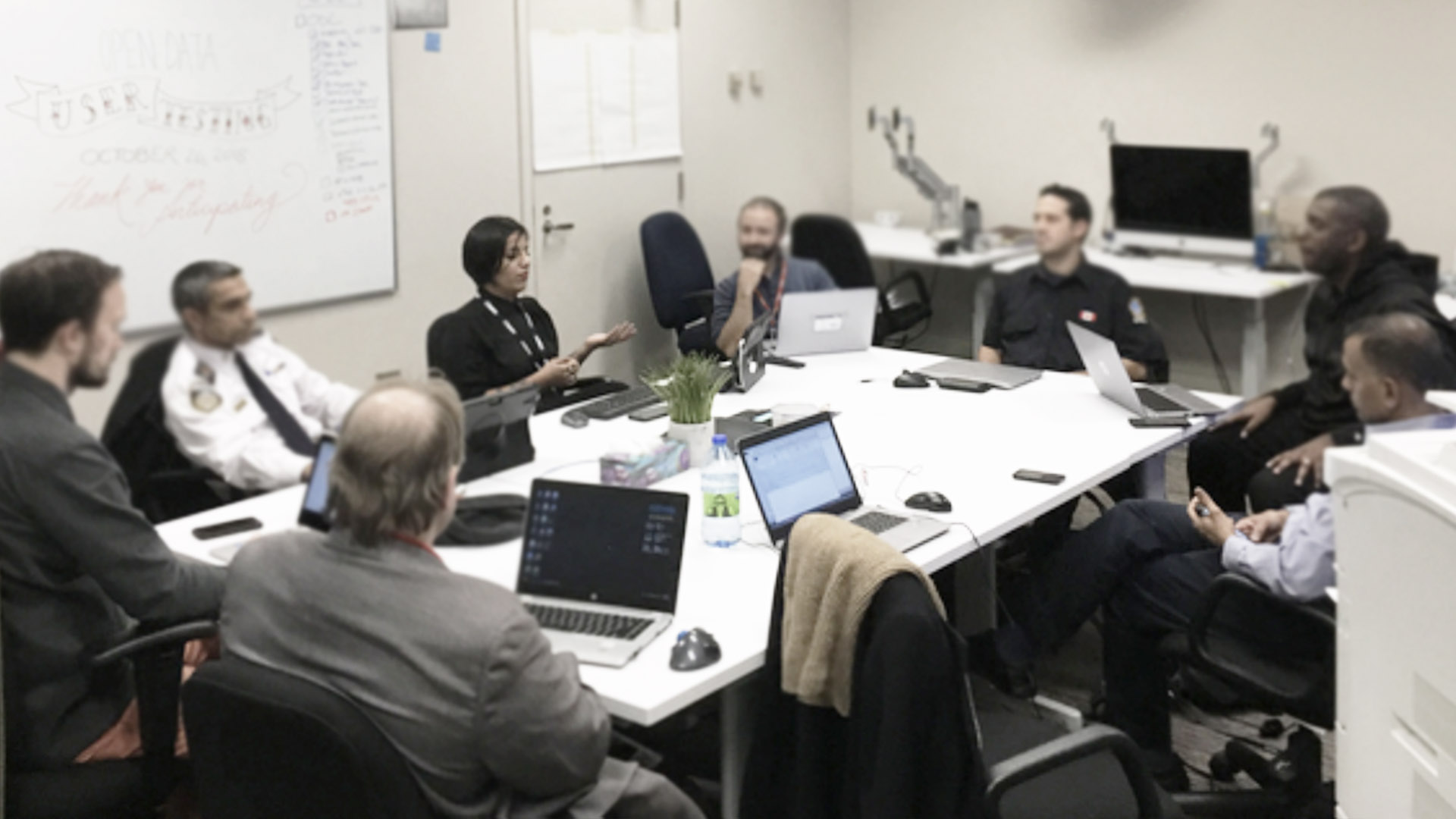 Partipants seated around a table discussing user testing